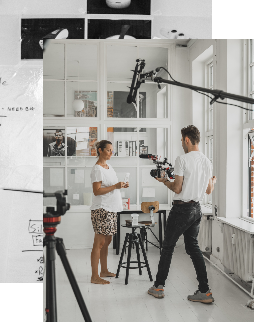 A videographer shooting someone in a white room full of art, surrounded by shooting equipment. Photo from Unsplash.com