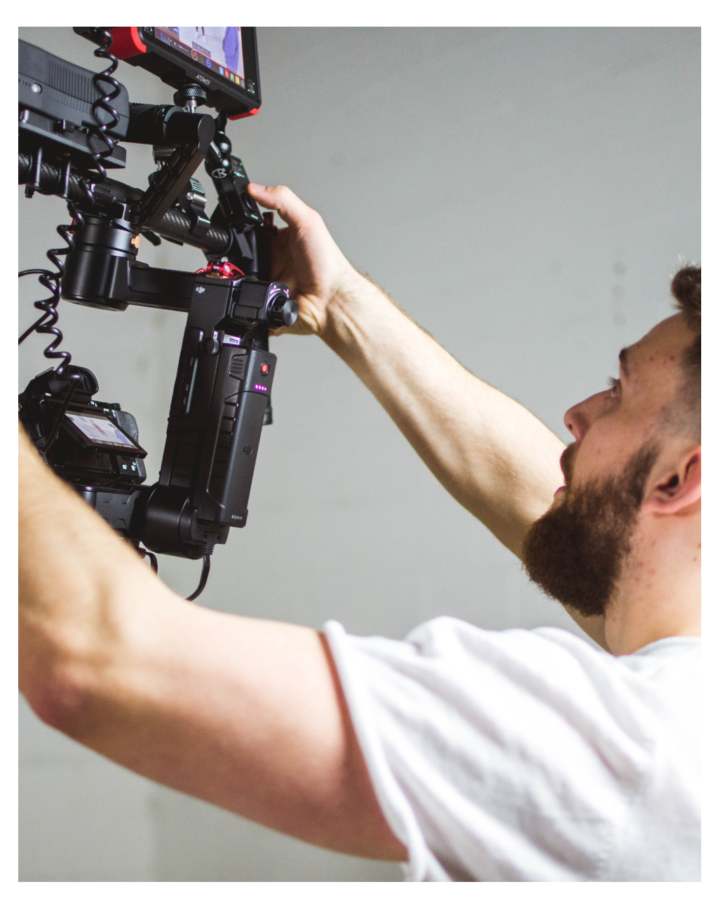 A videographer carrying elaborate video shooting equipment. Photo from Unsplash.com