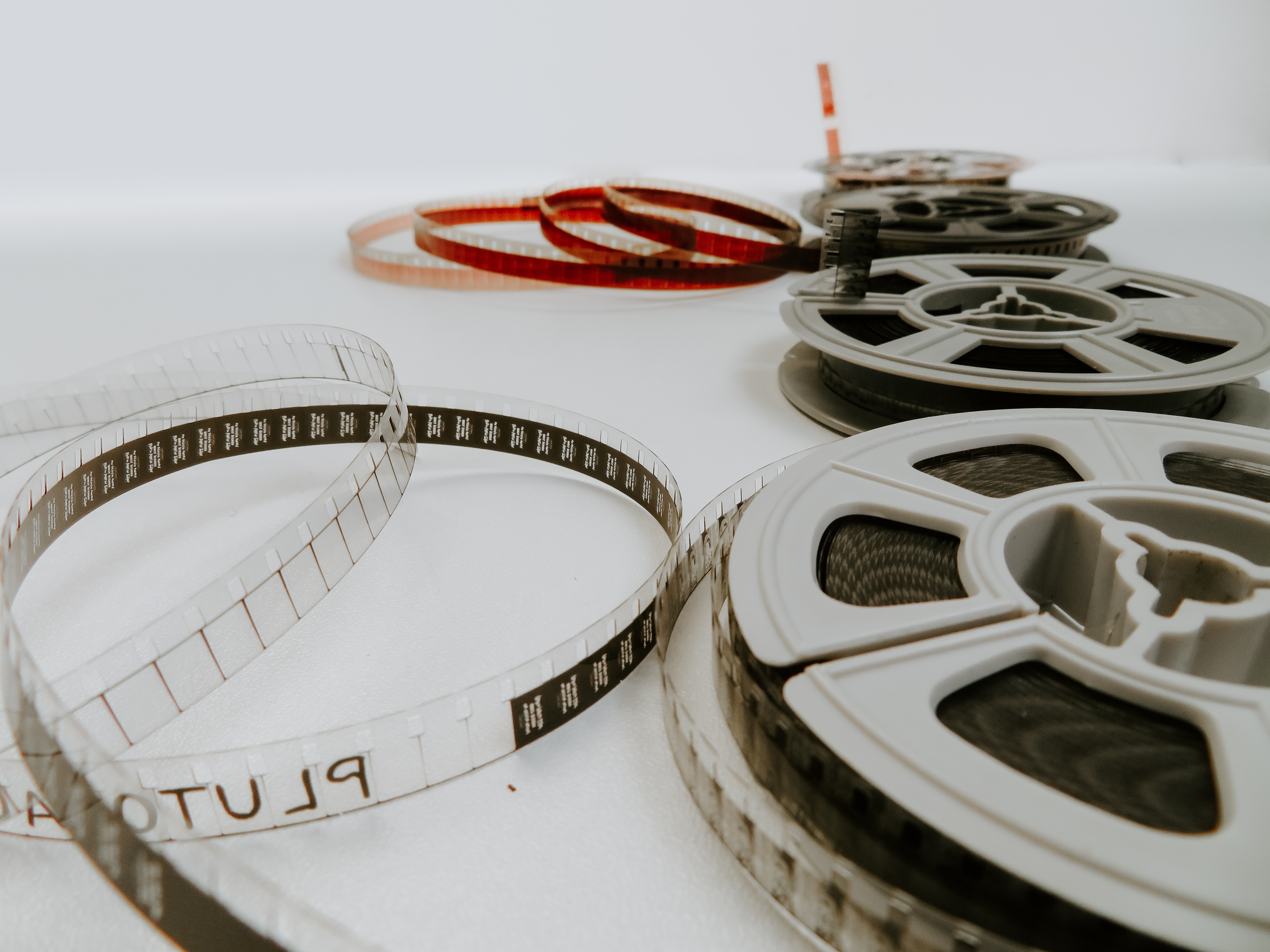 Four vintage film rolls sitting on a white background. Photo from Unsplash.com